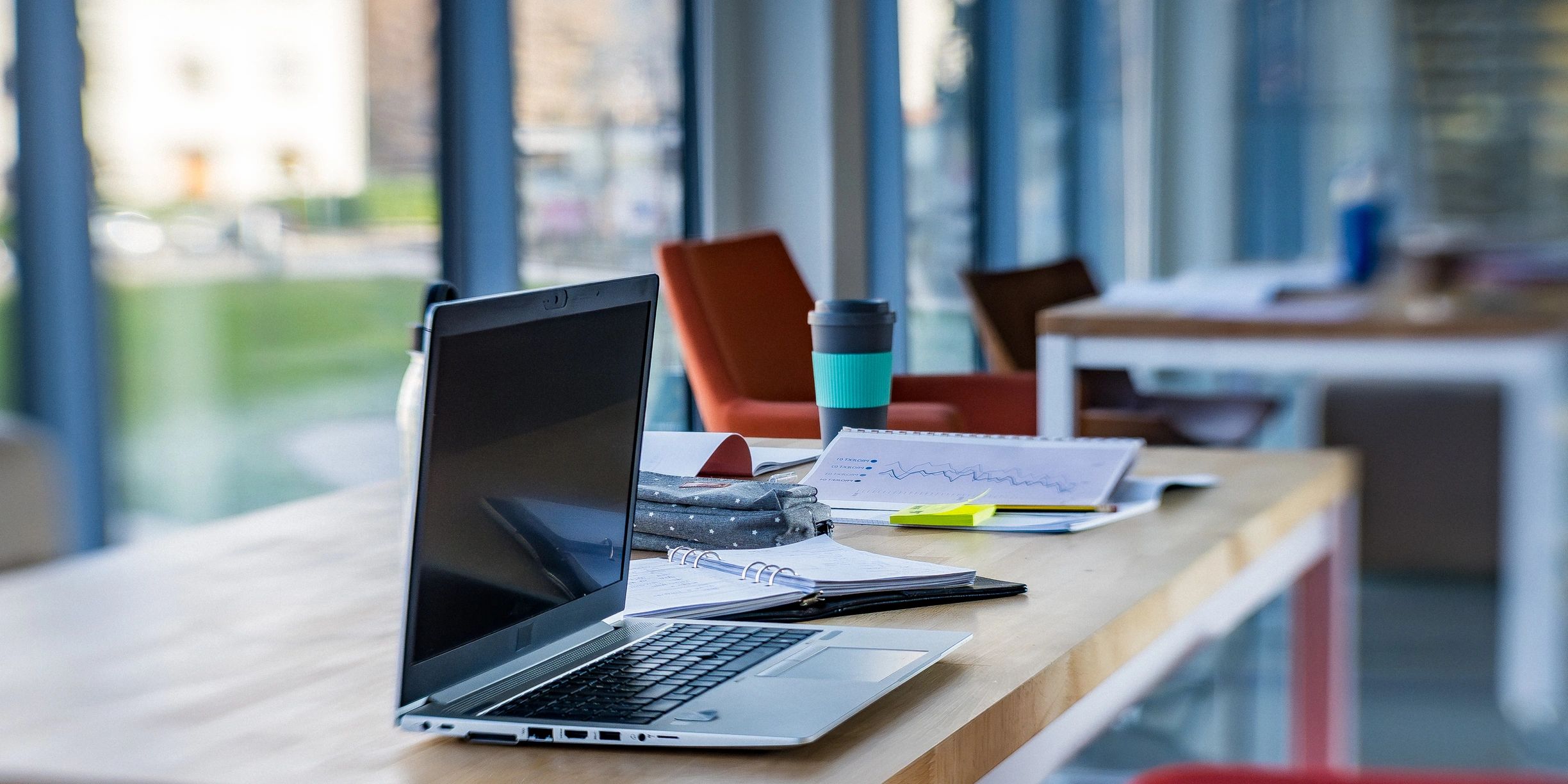 Modern office workspace with laptop and organized desk