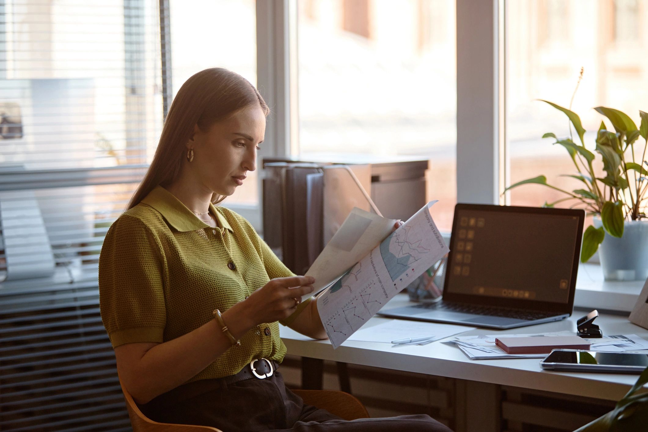 Professional reviewing reports and administrative documents in an office